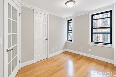 A room with a window and a door.