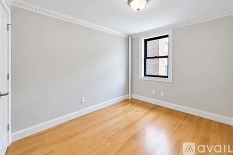 A room with wooden floors and a window.
