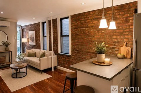 A modern kitchen with a brick wall and a dining area with a white couch.