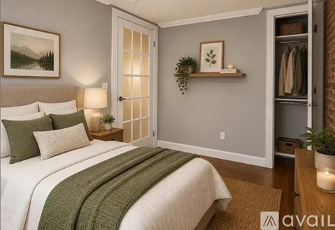 A bedroom with a bed, a nightstand with a lamp, a shelf with a plant and a closet.
