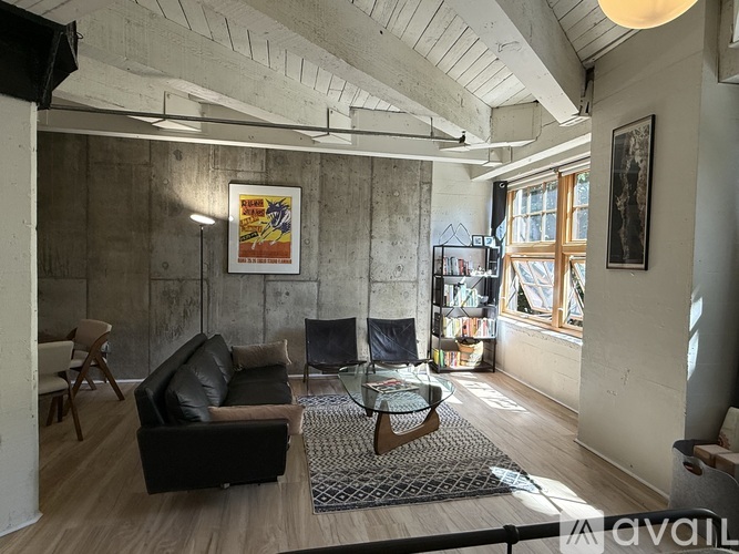 A living room with a couch, chair, and a coffee table.
