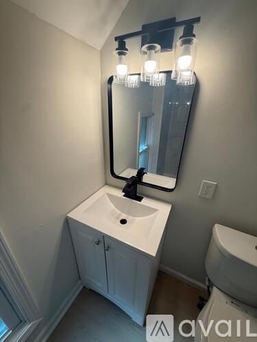 A bathroom with a sink and toilet.
