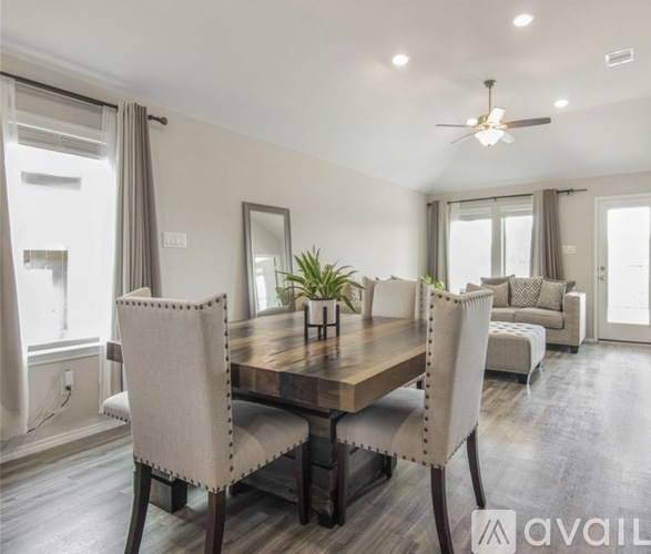 A dining room with a wooden table and chairs.