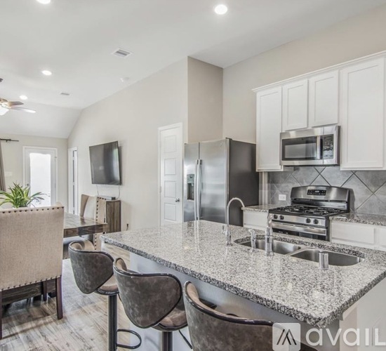 A kitchen with granite countertops and stainless steel appliances.