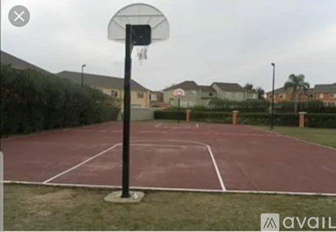 A basketball hoop is mounted on a pole in the middle of a basketball court.