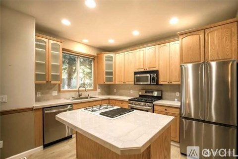 A kitchen with wooden cabinets and stainless steel appliances.