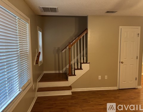 A room with a staircase and a door.