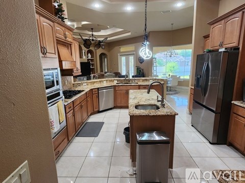 A kitchen with wooden cabinets and a granite countertop.