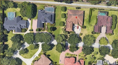 A bird's eye view of a residential area with houses and trees.