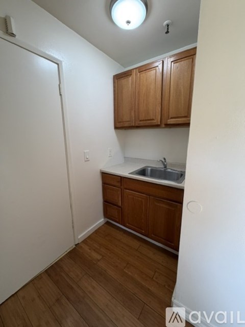 A kitchen with wooden cabinets and a white refrigerator.