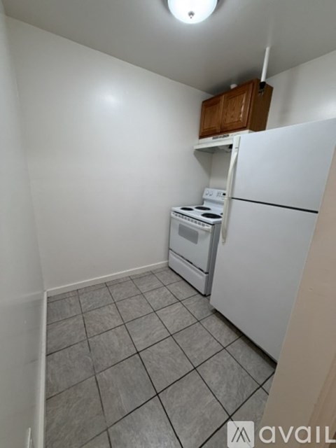 A kitchen with a white refrigerator, white oven, and white dishwasher.