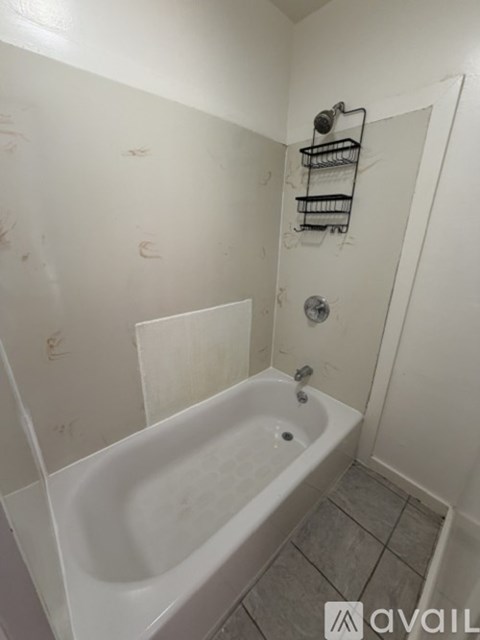 A white bathroom with a tub and a shower.
