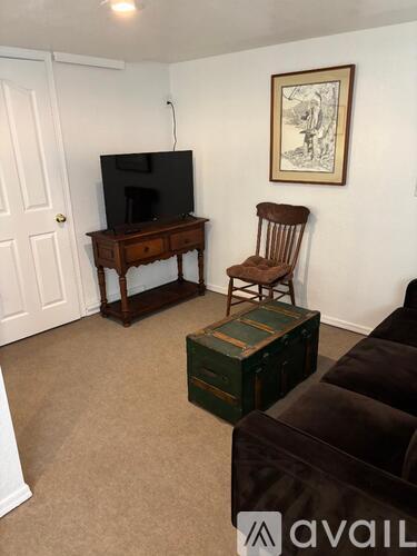 A living room with a brown chair and a brown couch.
