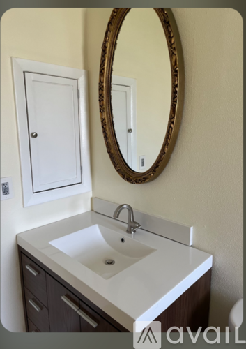 A bathroom with a sink and a mirror.