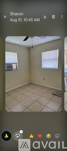 A room with beige walls and a tiled floor is shown.