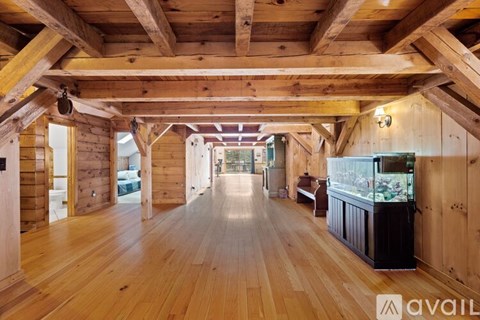 A spacious wooden interior with a long hallway and a counter on the right side.