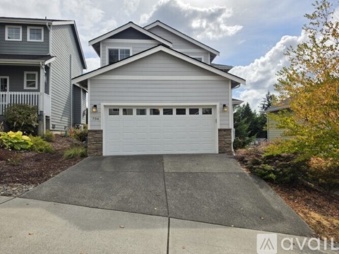 A two-story house with a garage is for sale.