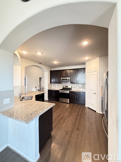 A kitchen with a countertop and cabinets is shown.