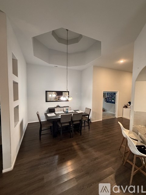 A dining room with a table set for four.
