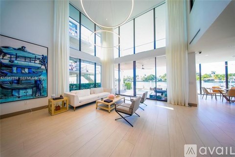A living room with a large painting on the wall and a white sofa.