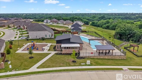 A bird's eye view of a residential area with a swimming pool and a playground.
