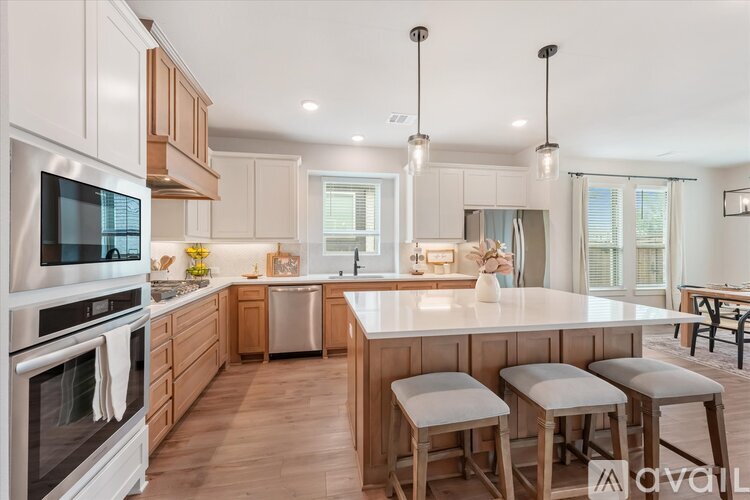 A modern kitchen with wooden cabinets and stainless steel appliances.