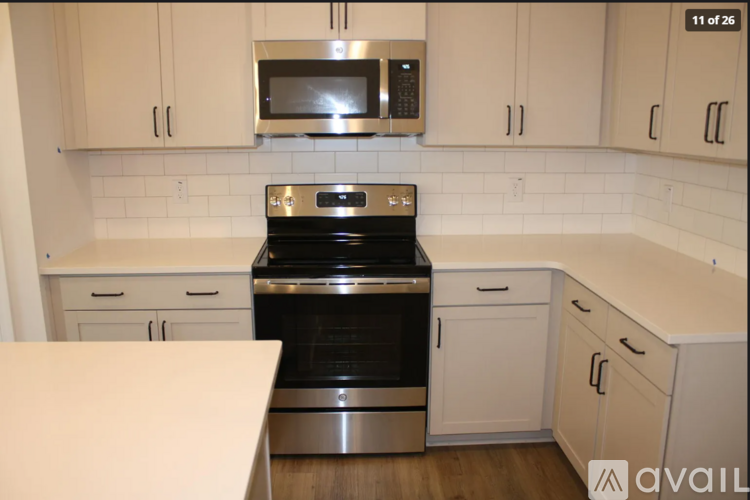 A kitchen with a stove top oven and microwave above it.