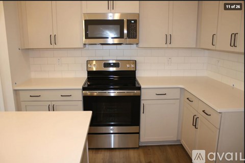 A kitchen with a stove top oven and microwave above it.