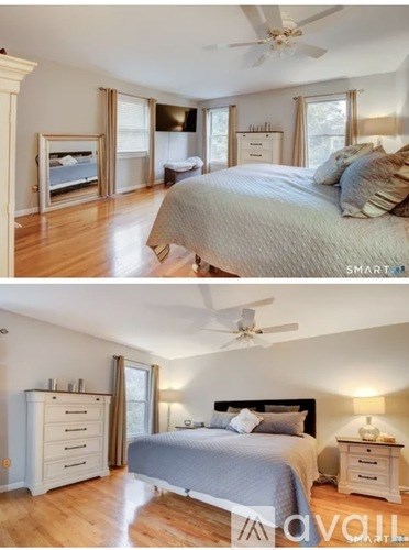 A bedroom with a large bed and a dresser.