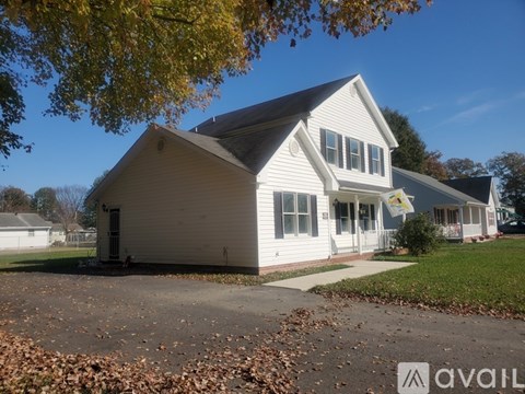 A house with a sign that says "AVAILABLE" in front of it.