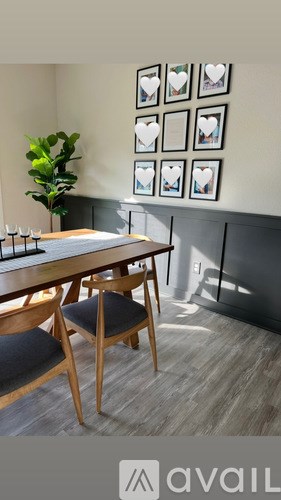 A dining room with a wooden table and chairs.