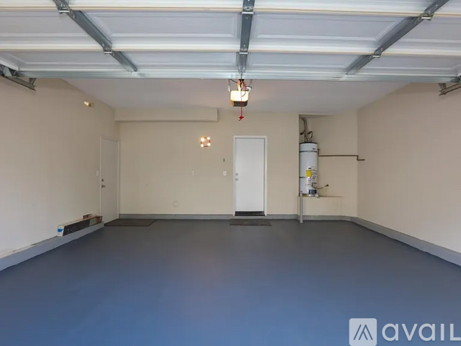 A spacious garage with a blue floor and white walls.