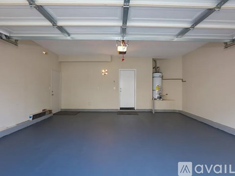 A spacious garage with a blue floor and white walls.
