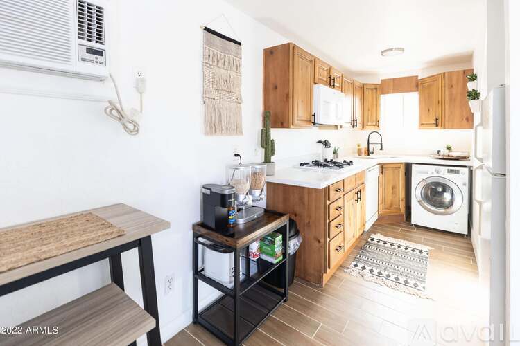 A kitchen with wooden cabinets and a white refrigerator.