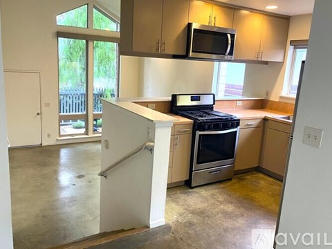 A kitchen with a stove top oven and microwave.