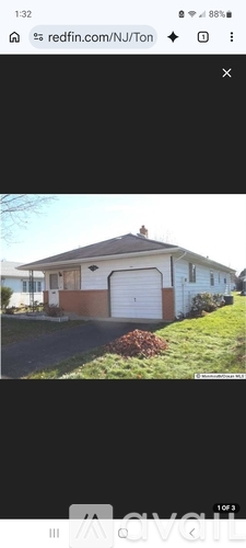A house with a white garage door is shown in the image.