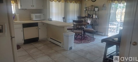 A kitchen with a white fridge and a white microwave.