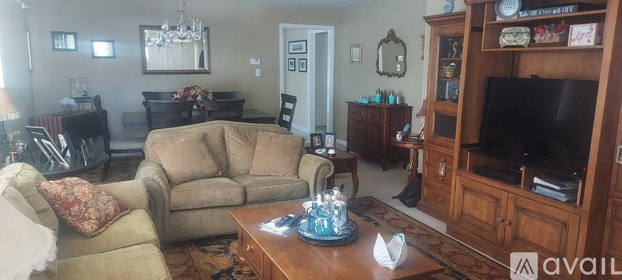 A living room with a couch, chair, and a coffee table.
