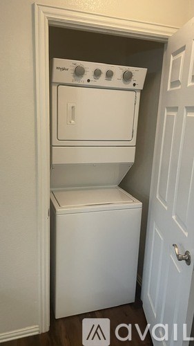 A white washing machine and dryer in a small laundry room.