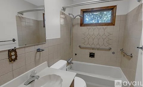 A bathroom with a white sink and a white toilet.