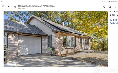 A house with a white garage door is for sale.