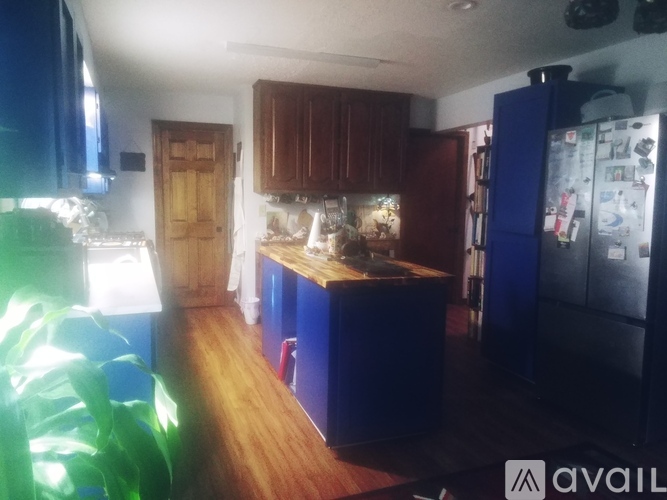 A kitchen with wooden cabinets and a blue fridge.
