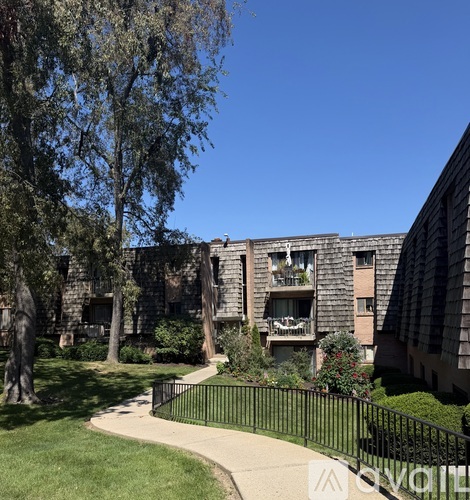 A sunny day at a residential area with apartment buildings and greenery.