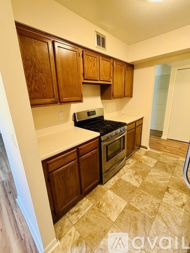 A kitchen with wooden cabinets and a black stove top oven.