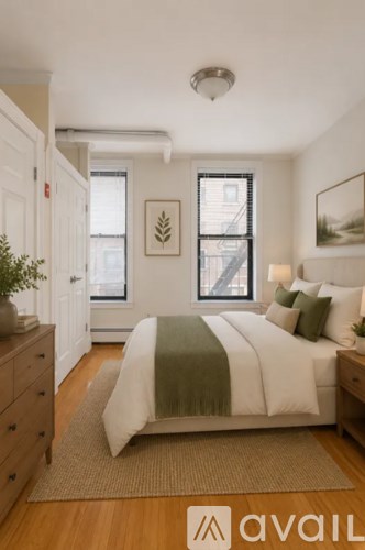 A bedroom with a bed, a dresser, and a window.