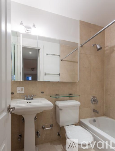 A bathroom with a sink, toilet, and bathtub.