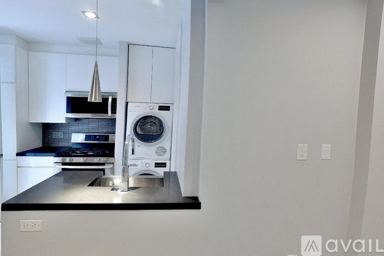 A modern kitchen with a stove, oven, and microwave.