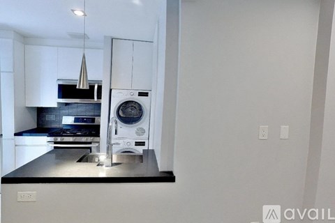 A modern kitchen with a stove, oven, and microwave.