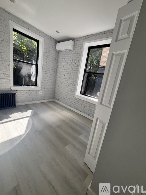A room with a white brick wall and a window.
