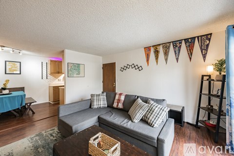 A living room with a grey couch and a wooden coffee table.